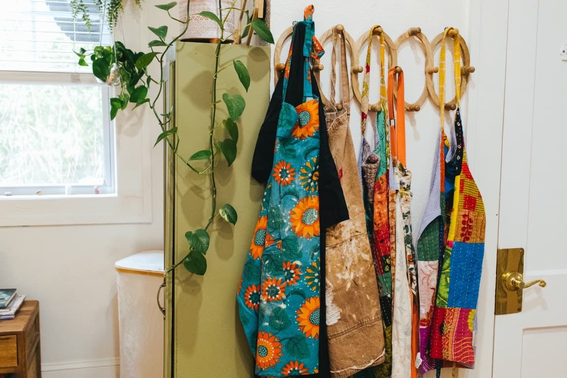 Colorful boutique pieces hanging in the studio