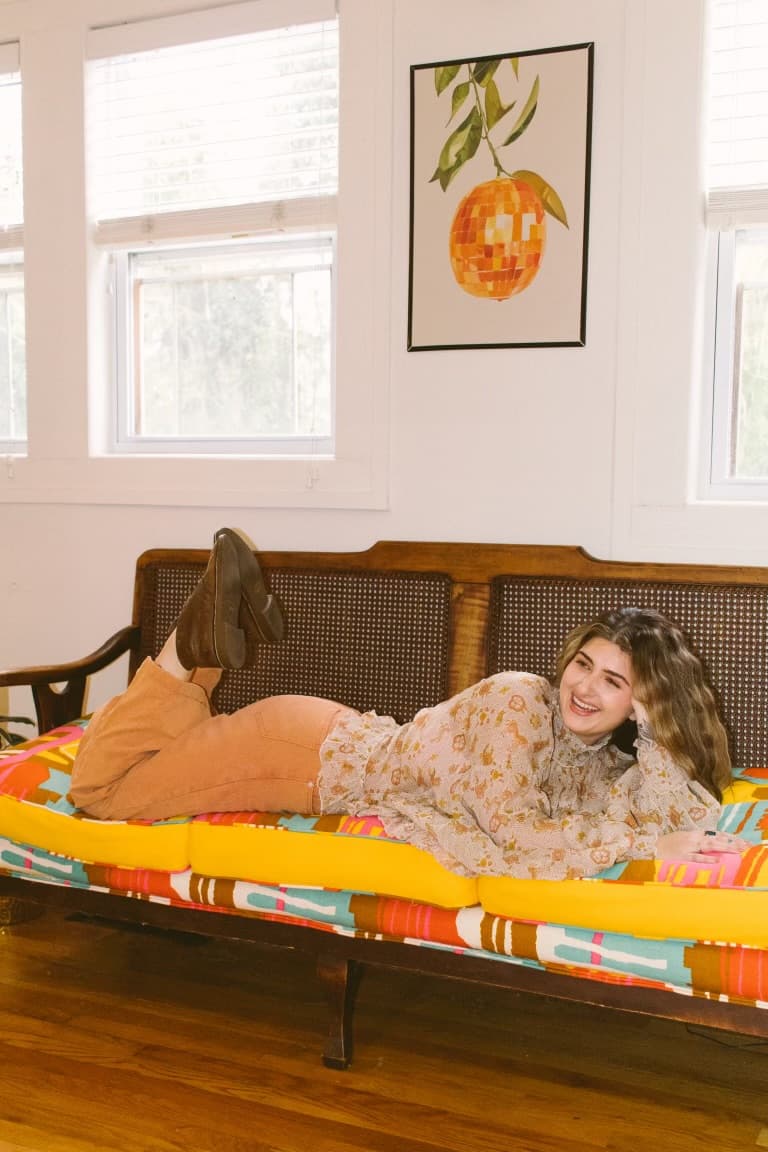 McKenzie relaxing on a colorful studio daybed
