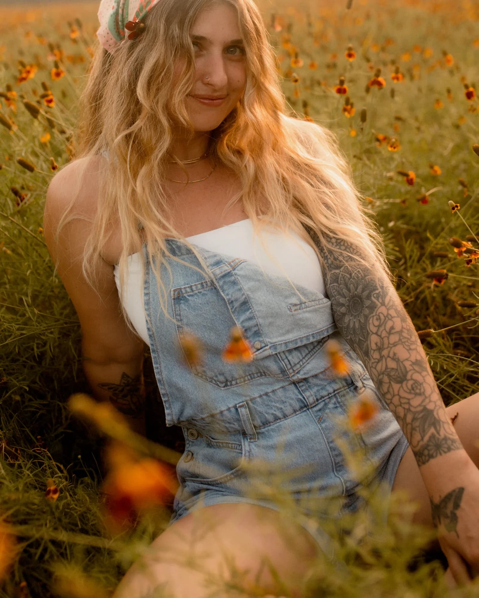 Mckenzie seated among wildflowers in warm evening light